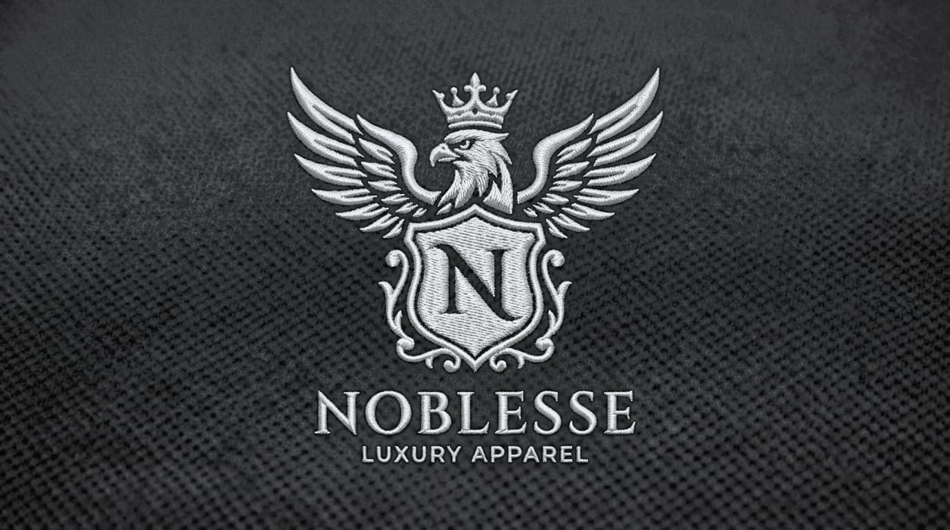 Physical 3D platinum white satin thread embroidery sew-out of the crest on black pique fabric